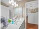 Bathroom with double vanity, bright lighting and closet at 13703 Drysdale Ave, Port Charlotte, FL 33981