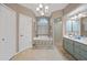 Neutral toned bathroom features a large tub, separate shower and double sink at 13703 Drysdale Ave, Port Charlotte, FL 33981