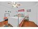 Bedroom with a white interior, ceiling fan, and a large window with plenty of light at 13703 Drysdale Ave, Port Charlotte, FL 33981