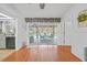 Bright dining area with sliding glass doors that open to an enclosed lanai and pool at 13703 Drysdale Ave, Port Charlotte, FL 33981