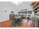 Dining room with wood floors, stylish decor, and natural light from the windows at 13703 Drysdale Ave, Port Charlotte, FL 33981