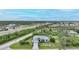Well-maintained single-Gathering home featuring manicured landscaping, palm trees, and a paver driveway at 13703 Drysdale Ave, Port Charlotte, FL 33981