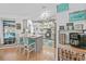 Bright kitchen features an island with seating, modern appliances, and stylish decor with a view of the pool at 13703 Drysdale Ave, Port Charlotte, FL 33981