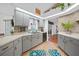 Updated kitchen features modern appliances, granite countertops, and ample cabinet space with views to other rooms at 13703 Drysdale Ave, Port Charlotte, FL 33981
