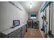 Well-organized laundry room with modern washer and dryer, ample storage, and stylish decor at 13703 Drysdale Ave, Port Charlotte, FL 33981
