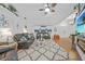 Spacious living room featuring vaulted ceilings, wood floors, and a cozy seating area at 13703 Drysdale Ave, Port Charlotte, FL 33981