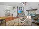 Relaxing living room with a fireplace, TV, and access to the lanai and dining area at 13703 Drysdale Ave, Port Charlotte, FL 33981