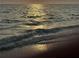 Golden ocean waves crash on a sandy shore at 13703 Drysdale Ave, Port Charlotte, FL 33981