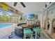 Relaxing enclosed patio with a hot tub, television, and convenient bar area at 13703 Drysdale Ave, Port Charlotte, FL 33981