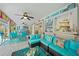 Inviting enclosed patio with comfortable seating, ceiling fans, and nautical decor at 13703 Drysdale Ave, Port Charlotte, FL 33981