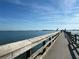 A wooden pier stretches out into the ocean on a sunny day at 13703 Drysdale Ave, Port Charlotte, FL 33981