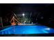 Screened-in pool illuminated at night with festive lighting and inviting atmosphere at 13703 Drysdale Ave, Port Charlotte, FL 33981