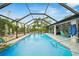 Spacious screened-in pool area with outdoor seating and bar area for entertaining at 13703 Drysdale Ave, Port Charlotte, FL 33981