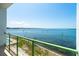 Balcony overlooking water with green space and a distant view of buildings at 1375 Beach Rd # 201, Englewood, FL 34223