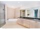 Elegant bathroom features double sinks, a soaking tub, and a glass enclosed shower at 1375 Beach Rd # 201, Englewood, FL 34223