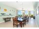 Spacious dining room with stylish furniture and water views from the bright, sunlit windows at 1375 Beach Rd # 201, Englewood, FL 34223