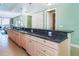 Kitchen with granite countertops and light wood cabinetry near a large living and dining area at 1375 Beach Rd # 201, Englewood, FL 34223