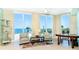 Bright living room boasts water views from three large windows, stylish furnishings, and tiled floors at 1375 Beach Rd # 201, Englewood, FL 34223