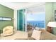 Cozy living room with water views and access to a covered balcony for outdoor dining and relaxation at 1375 Beach Rd # 201, Englewood, FL 34223