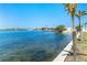 Scenic waterfront view featuring palm trees, bridge, and blue water at 1375 Beach Rd # 201, Englewood, FL 34223