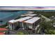 A scenic aerial view showing condos with mature landscaping, next to a bay at sunset at 1501 Beach Rd # 310, Englewood, FL 34223