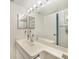 Bright and clean bathroom with a wide mirror and ample countertop space at 1501 Beach Rd # 310, Englewood, FL 34223