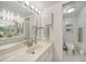 A well-lit bathroom features a sink, large mirror, and adjacent toilet and shower area at 1501 Beach Rd # 310, Englewood, FL 34223