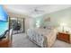 A serene bedroom features a ceiling fan and sliding glass doors to a screened-in lanai at 1501 Beach Rd # 310, Englewood, FL 34223
