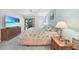 Bright bedroom with a comfortable bed, dresser, and a sliding glass door leading to the outdoor patio at 1501 Beach Rd # 310, Englewood, FL 34223