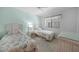 Bright second bedroom features two twin beds, ceiling fan, and a beach-themed decor at 1501 Beach Rd # 310, Englewood, FL 34223