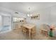 Bright dining area with light-colored carpet, a wooden dining table and a kitchen pass-through at 1501 Beach Rd # 310, Englewood, FL 34223