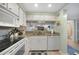 Bright kitchen with an oven, microwave, dishwasher, and double sink at 1501 Beach Rd # 310, Englewood, FL 34223