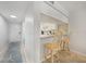 Bright kitchen with white cabinets, breakfast bar, and an entryway door at 1501 Beach Rd # 310, Englewood, FL 34223