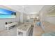 Inviting living room featuring neutral tones, comfortable seating, and a beach scene on the TV for a relaxing atmosphere at 1501 Beach Rd # 310, Englewood, FL 34223