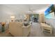 Cozy living room with comfortable seating, a television, and a view of the outdoor patio at 1501 Beach Rd # 310, Englewood, FL 34223