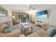Inviting living room with cozy seating, beach-themed decor, and a sliding glass door to the outdoor patio at 1501 Beach Rd # 310, Englewood, FL 34223