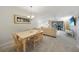 Open-concept living space featuring dining area, carpet, ceiling fan, and lanai access at 1501 Beach Rd # 310, Englewood, FL 34223