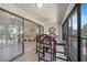 Relaxing screened patio with high top seating, offering views of the living room through sliding glass doors at 1501 Beach Rd # 310, Englewood, FL 34223