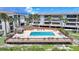 Overhead view of community pool with wooden deck and patio area at 1501 Beach Rd # 310, Englewood, FL 34223
