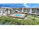 Aerial view of condo community swimming pool and deck with seating at 1501 Beach Rd # 310, Englewood, FL 34223