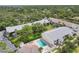 Aerial view of building, pool, and surroundings with lush greenery at 1730 Manasota Beach Rd # 204, Englewood, FL 34223