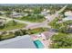 Aerial view showcases community pool, lush surroundings, and proximity to the ocean at 1730 Manasota Beach Rd # 204, Englewood, FL 34223