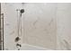 Bright bathroom showcasing a shower with white marble tile and modern fixtures at 1730 Manasota Beach Rd # 204, Englewood, FL 34223
