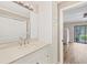 Bathroom featuring vanity with modern sink, modern floors, and view to bedroom at 1730 Manasota Beach Rd # 204, Englewood, FL 34223
