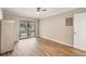 Bedroom featuring modern floors, sliding glass door to balcony, and ceiling fan at 1730 Manasota Beach Rd # 204, Englewood, FL 34223