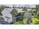 Condo exterior view featuring lush landscaping, palm trees, and a well-maintained facade at 1730 Manasota Beach Rd # 204, Englewood, FL 34223
