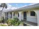 Condo's exterior features archways, a balcony, and lush tropical landscaping at 1730 Manasota Beach Rd # 204, Englewood, FL 34223