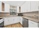 Updated kitchen featuring white cabinets, stainless steel appliances, and granite countertops at 1730 Manasota Beach Rd # 204, Englewood, FL 34223