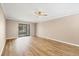 Spacious living room with new wood flooring and ceiling fan at 1730 Manasota Beach Rd # 204, Englewood, FL 34223