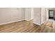 Open-concept living area with wood-look floors, neutral paint, and a sliding glass door at 1730 Manasota Beach Rd # 204, Englewood, FL 34223